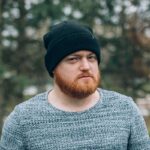 young man with redhead beard and cap