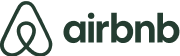 The Airbnb logo displayed in green letters, representing a welcoming and innovative approach to accommodation.